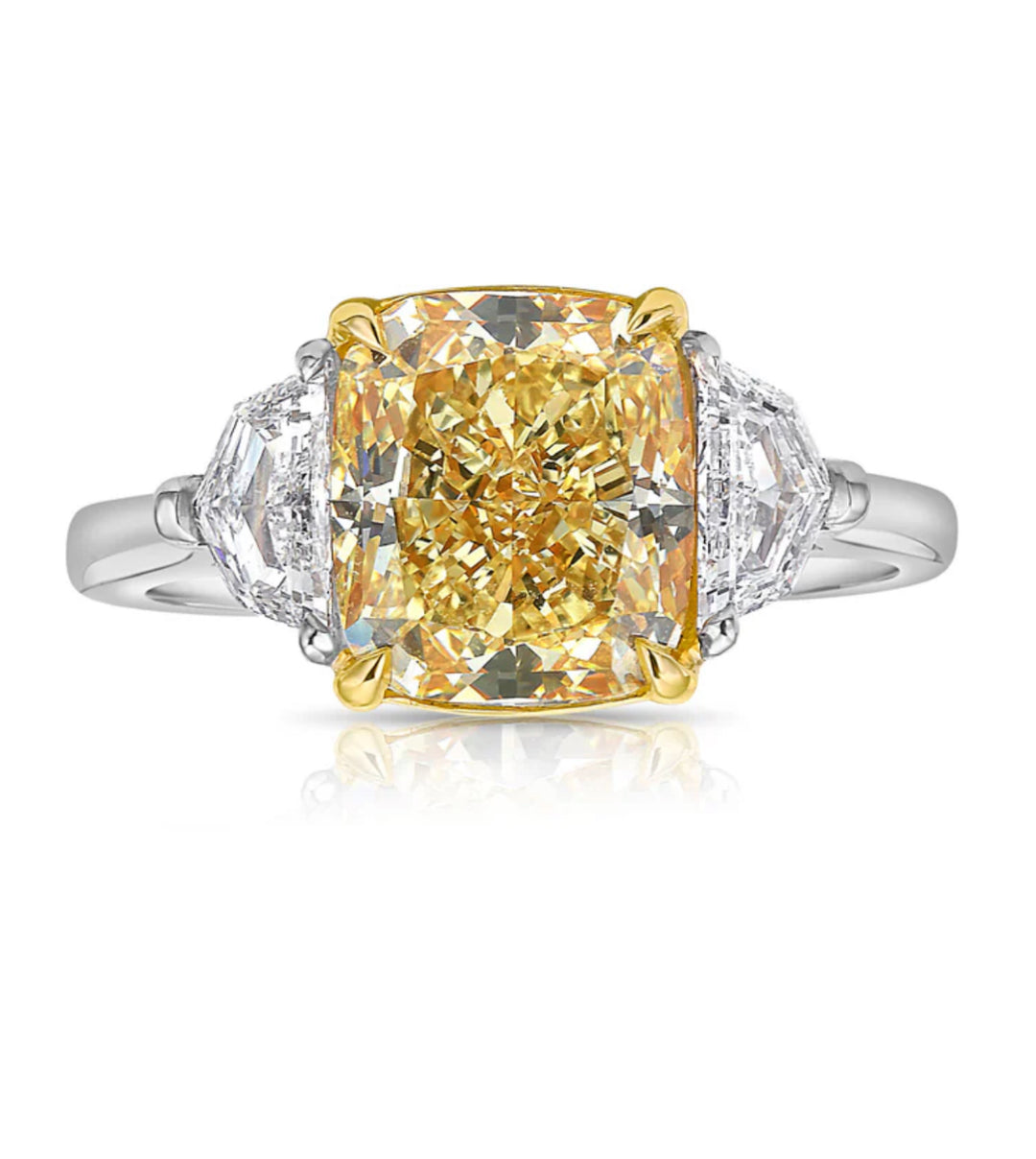 5ct Yellow cushion-cut diamond three-stone ring with epaulette side diamonds in platinum and 18k yellow gold.