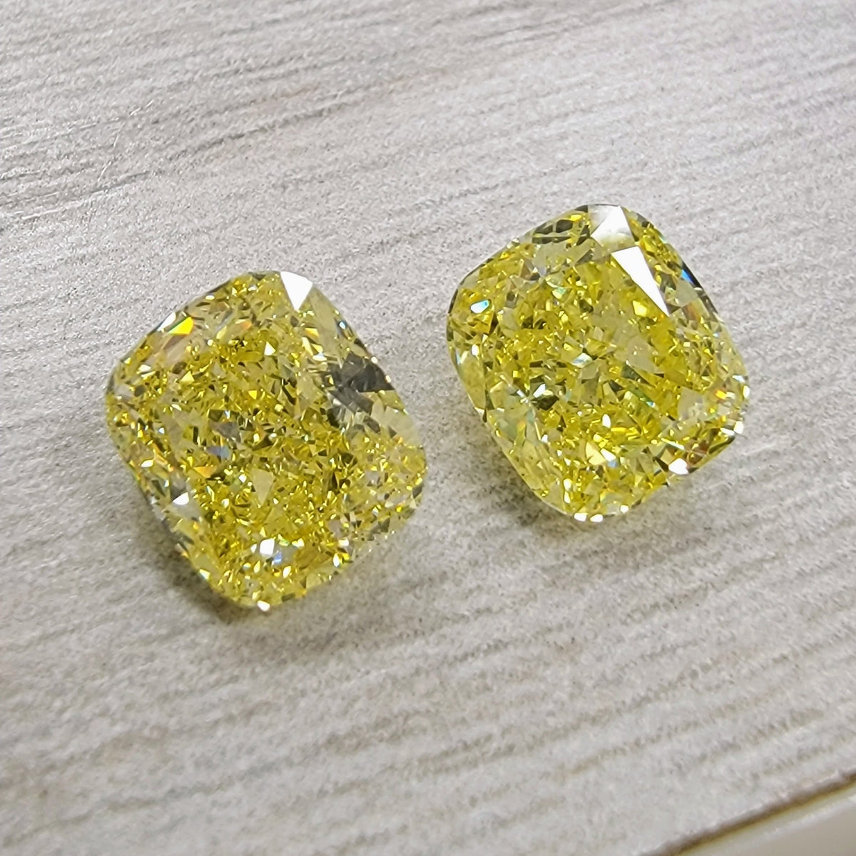 2.01ct & 2.00ct Fancy Intense Yellow Cushion Diamonds SI2 GIA