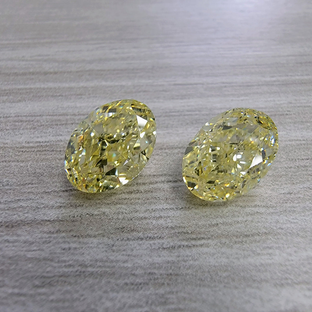 3.00ct & 3.00ct Fancy Light Yellow Oval Diamonds GIA