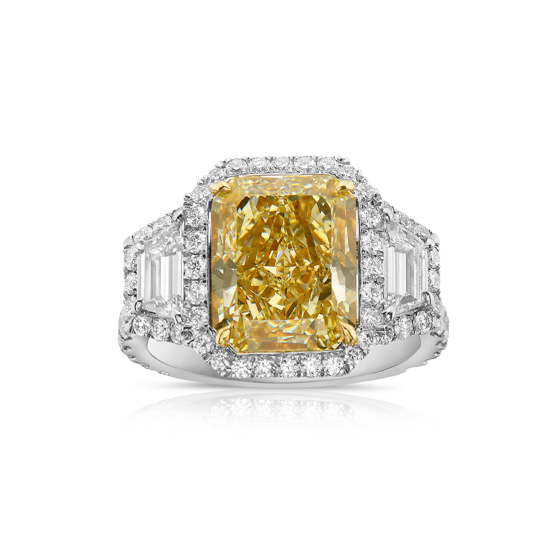 5.14ct Light Yellow elongated radiant diamond ring with trapezoid side stones and white diamond halos.
